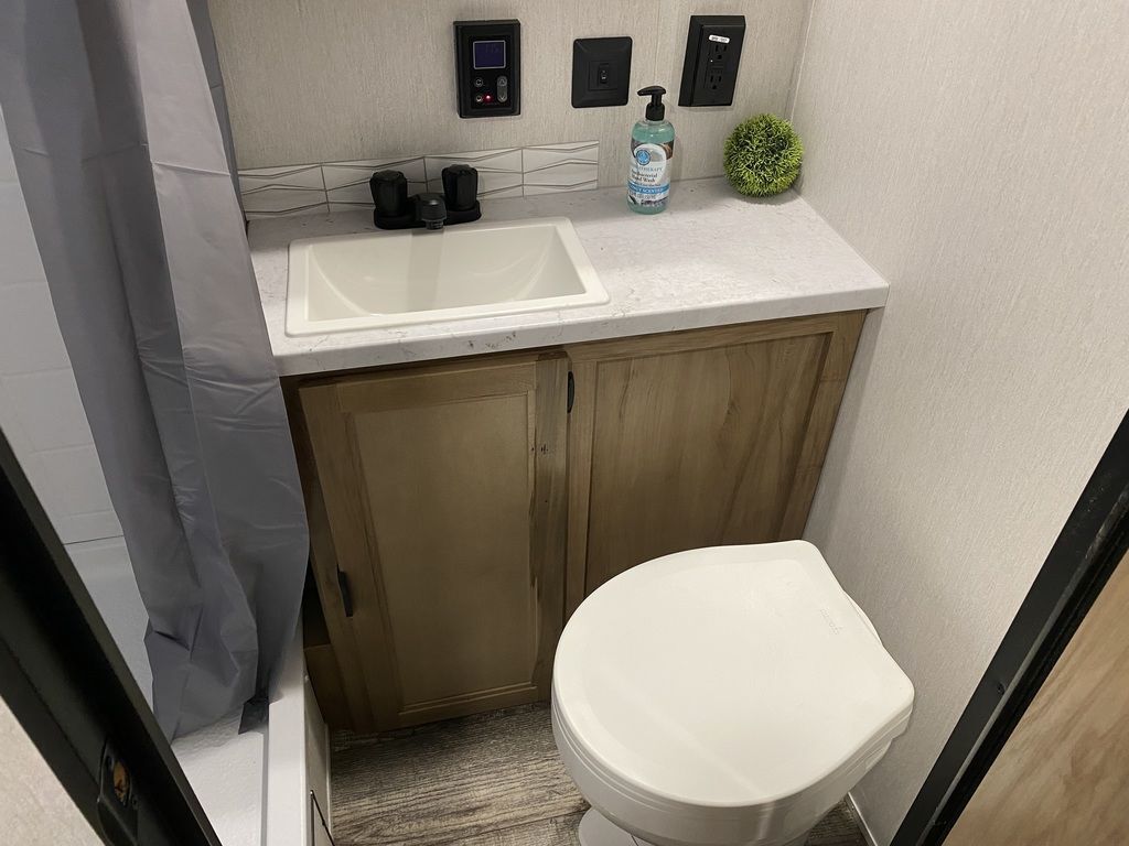 Bathroom with a sink, toilet and a walk-in shower.