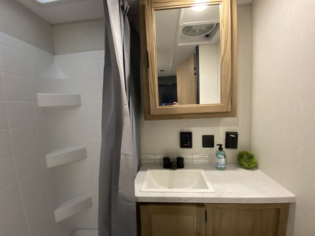 Bathroom with a sink, medicine cabinet and a walk-in shower.