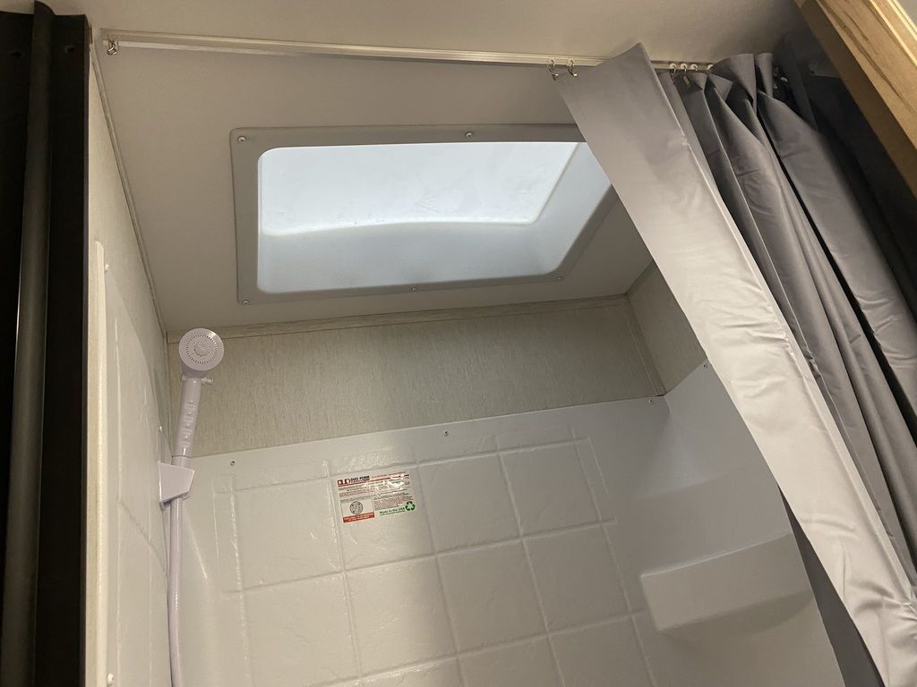 Bathroom with a walk-in shower and a skylight.