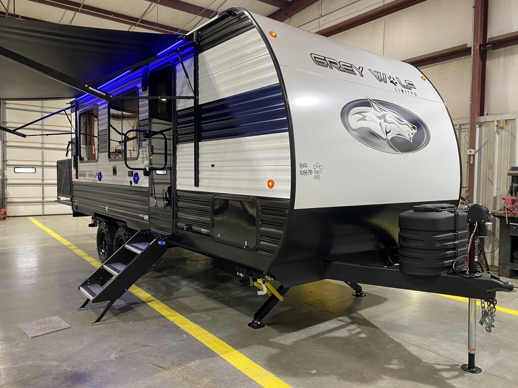 Side view of the New 2024 Forest River Cherokee Grey Wolf 18RR Travel Trailer Toy Hauler RV.