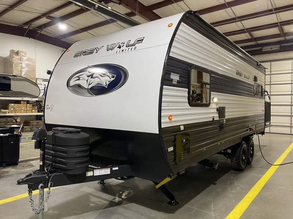 Side view of the New 2024 Forest River Cherokee Grey Wolf 18RR Travel Trailer Toy Hauler RV.