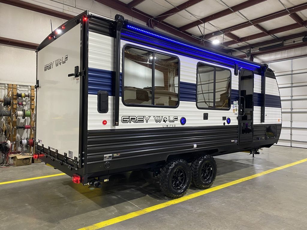 Side view of the New 2024 Forest River Cherokee Grey Wolf 18RR Travel Trailer Toy Hauler RV.