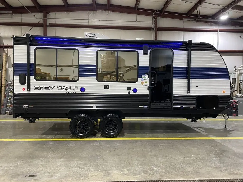 Side view of the New 2024 Forest River Cherokee Grey Wolf 18RR Travel Trailer Toy Hauler RV.