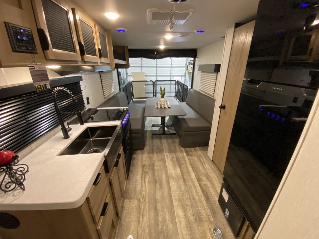 Interior view of the RV with a dinette and a kitchen.