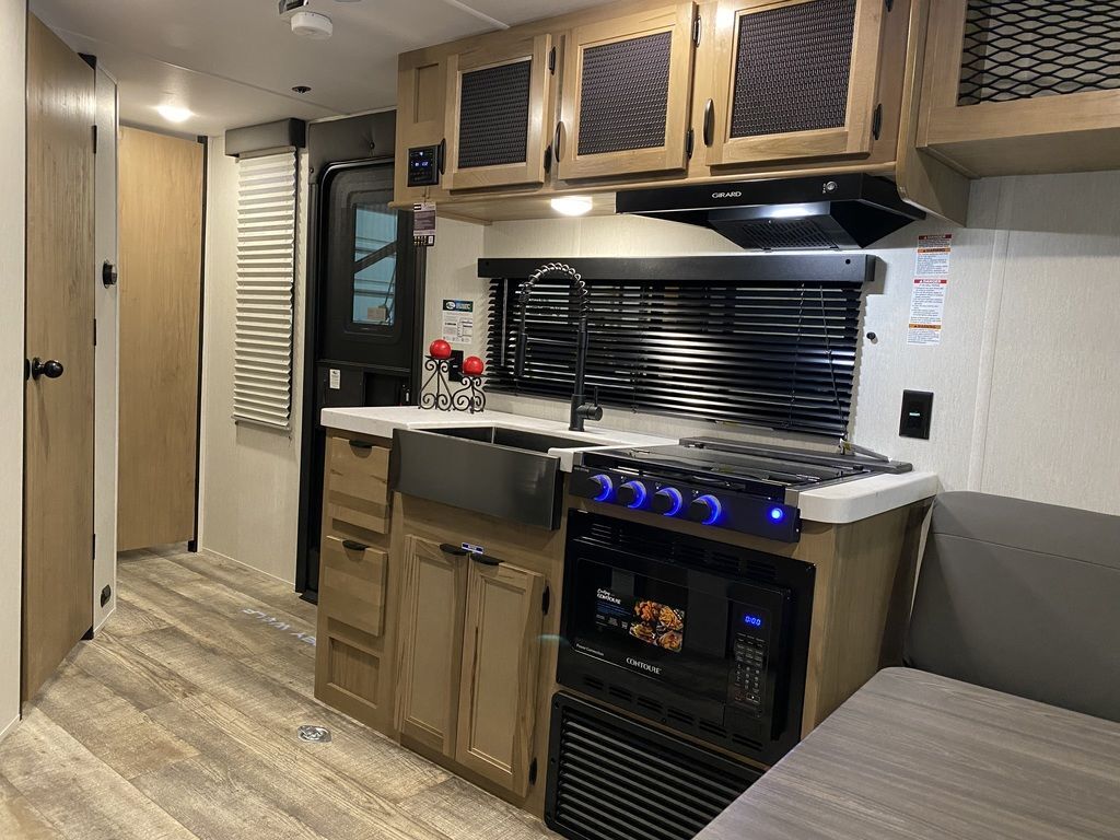 Kitchen with a gas range, oven, sink and cabinets.