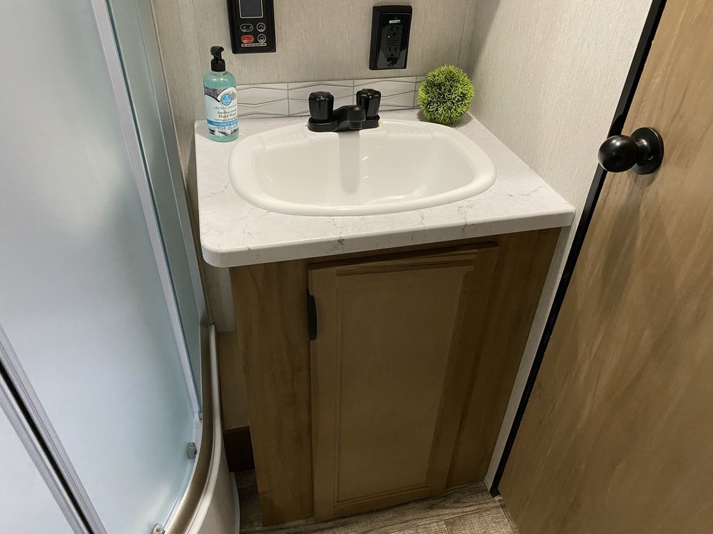 Bathroom with a sink and a walk-in shower.