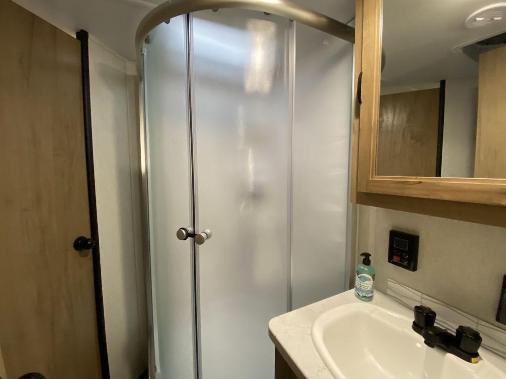 Bathroom with a sink, medicine cabinet and a walk-in shower.