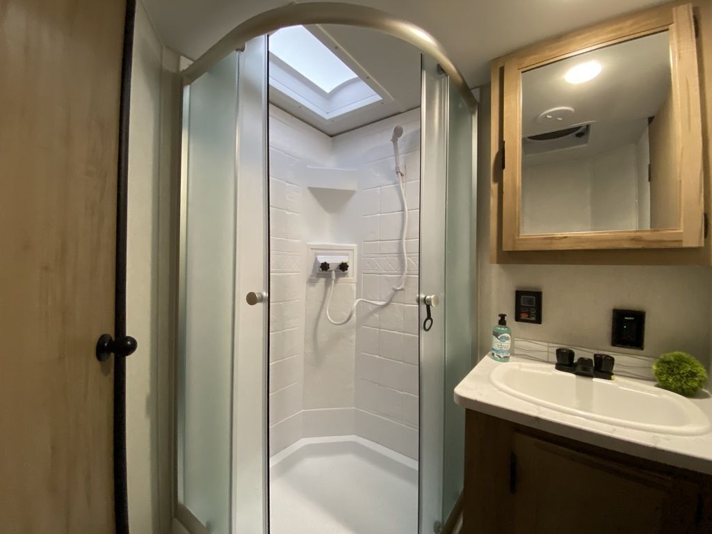 Bathroom with a sink, medicine cabinet and a walk-in shower.