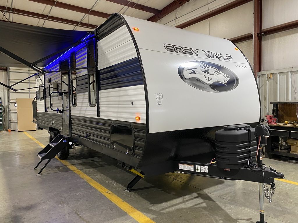 Side view of the New 2024 Forest River Cherokee Grey Wolf 22RR Travel Trailer Toy Hauler RV.