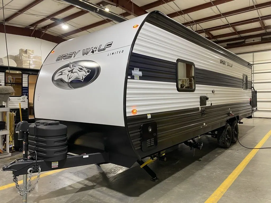 Side view of the New 2024 Forest River Cherokee Grey Wolf 22RR Travel Trailer Toy Hauler RV.