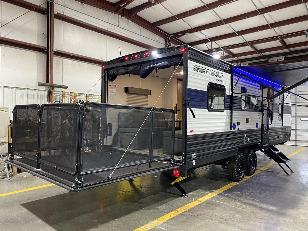 Side view of the New 2024 Forest River Cherokee Grey Wolf 22RR Travel Trailer Toy Hauler RV.