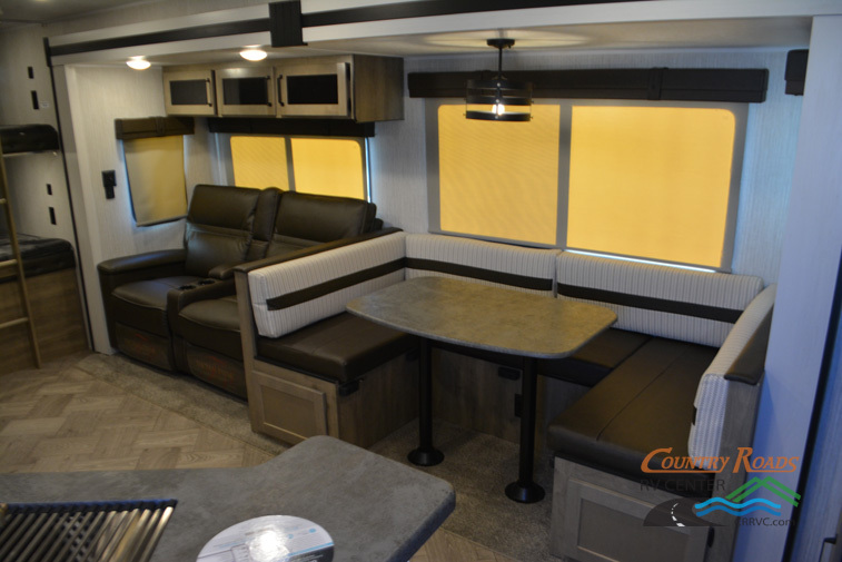 Interior view of the RV with a dinette and a living space.