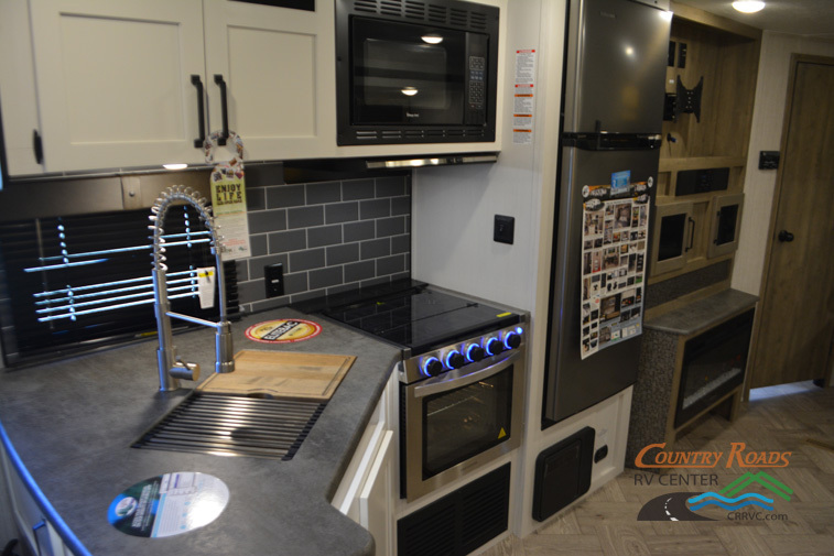 Kitchen with a gas range, fridge, oven, sink and cabinets.