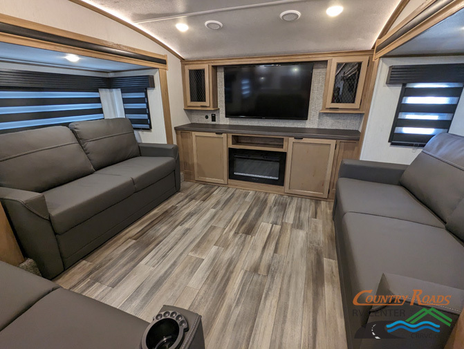  Living space with leather seats, TV and a fireplace.