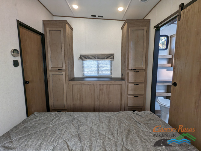 Bedroom with a king size bed and shirt closets.