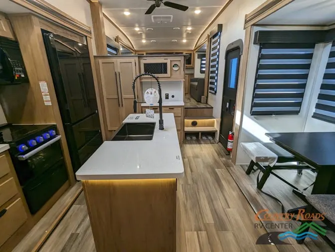 Interior view of the RV with a dinette and a kitchen.