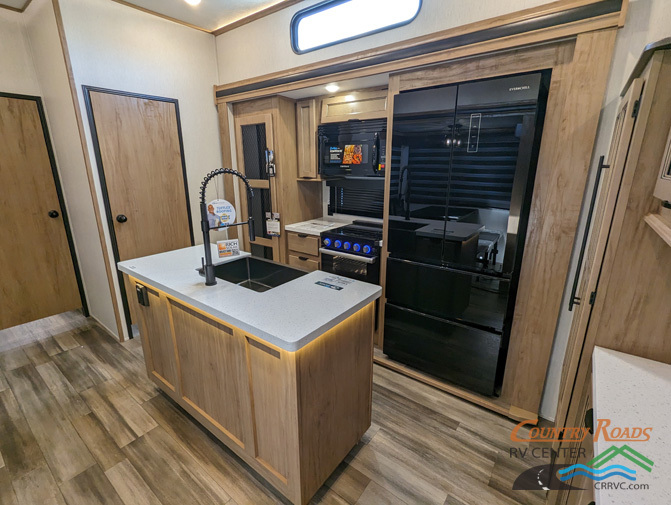 Kitchen with a gas range, fridge, oven, sink and cabinets.