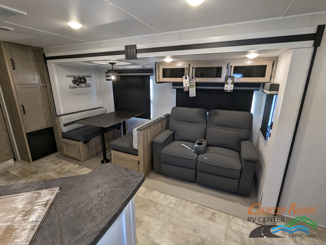 Interior view of the RV with a dinette and a living space.