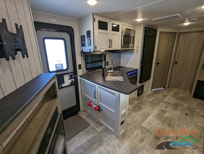 Kitchen with a gas range, fridge, oven, sink and cabinets.