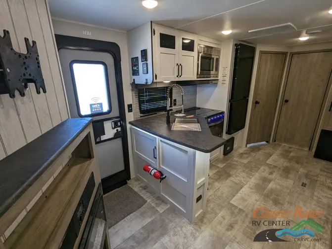 Kitchen with a gas range, fridge, oven, sink and cabinets.