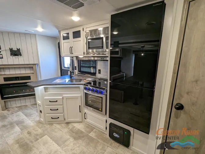 Kitchen with a gas range, fridge, oven, sink and cabinets.