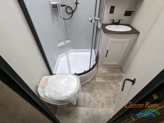 Bathroom with a sink, toilet and a walk-in shower.