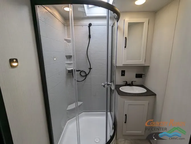 Bathroom with a sink, medicine cabinet and a walk-in shower.