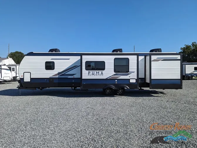 Side view of the New 2024 Palomino PUMA 32BHQS Travel Trailer RV.