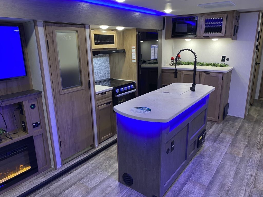 Kitchen with a gas range, fridge, oven, sink and cabinets.