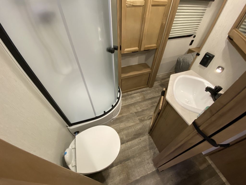 Bathroom with a sink, toilet and a walk-in shower.