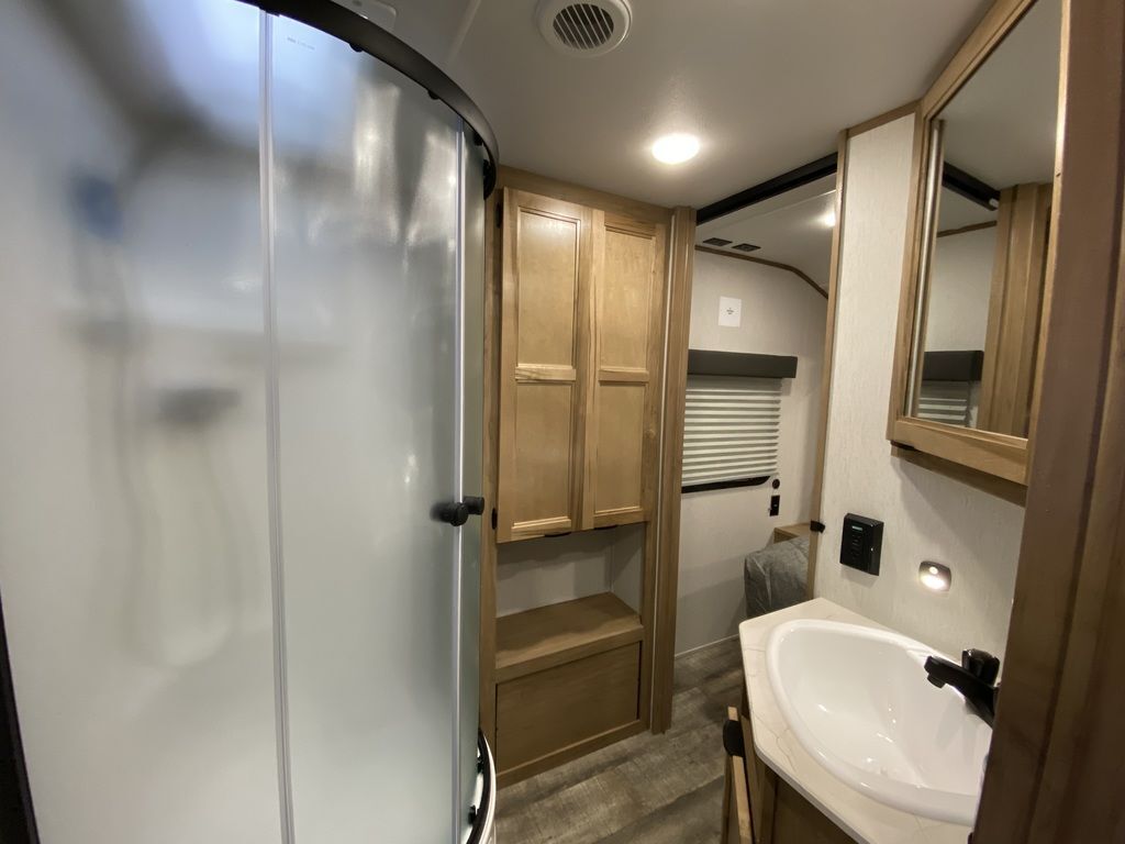 Bathroom with a sink, medicine cabinet and a walk-in shower.