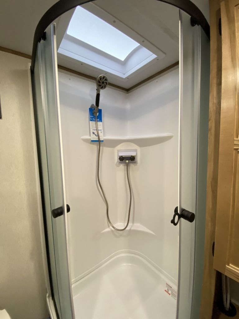 Bathroom with a walk-in shower and skylight.