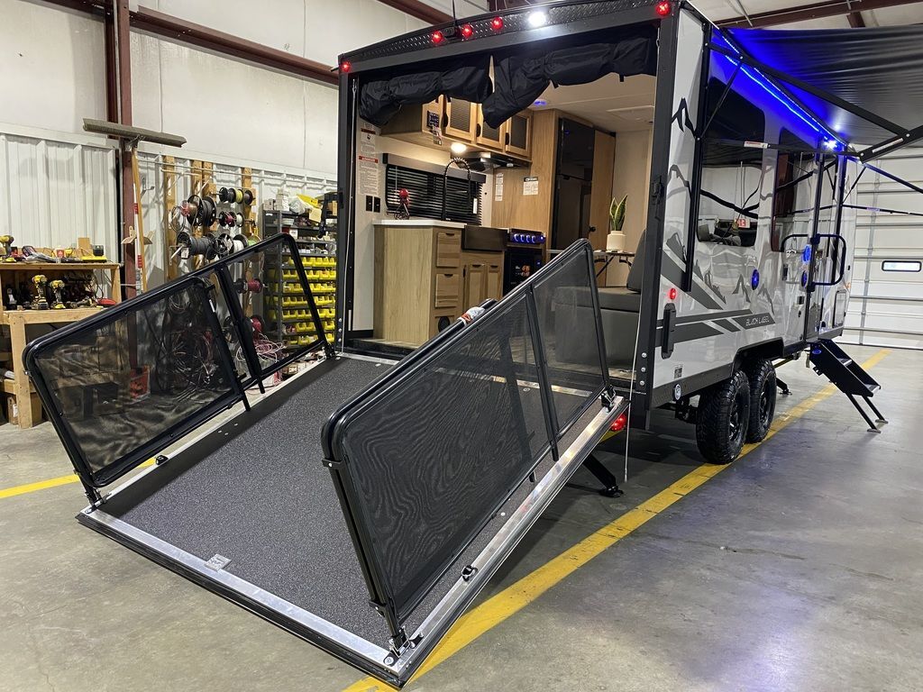 Rear view of the RV with a ramp.