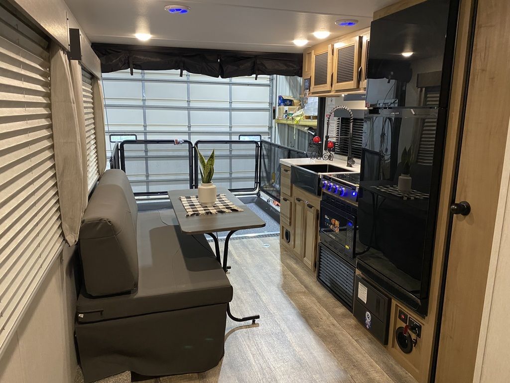 Interior view of the RV with a dinette and a kitchen.