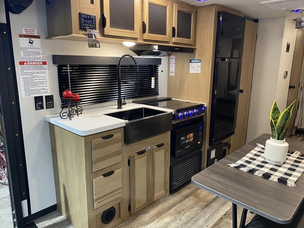 Kitchen with a gas range, fridge, sink and cabinets.