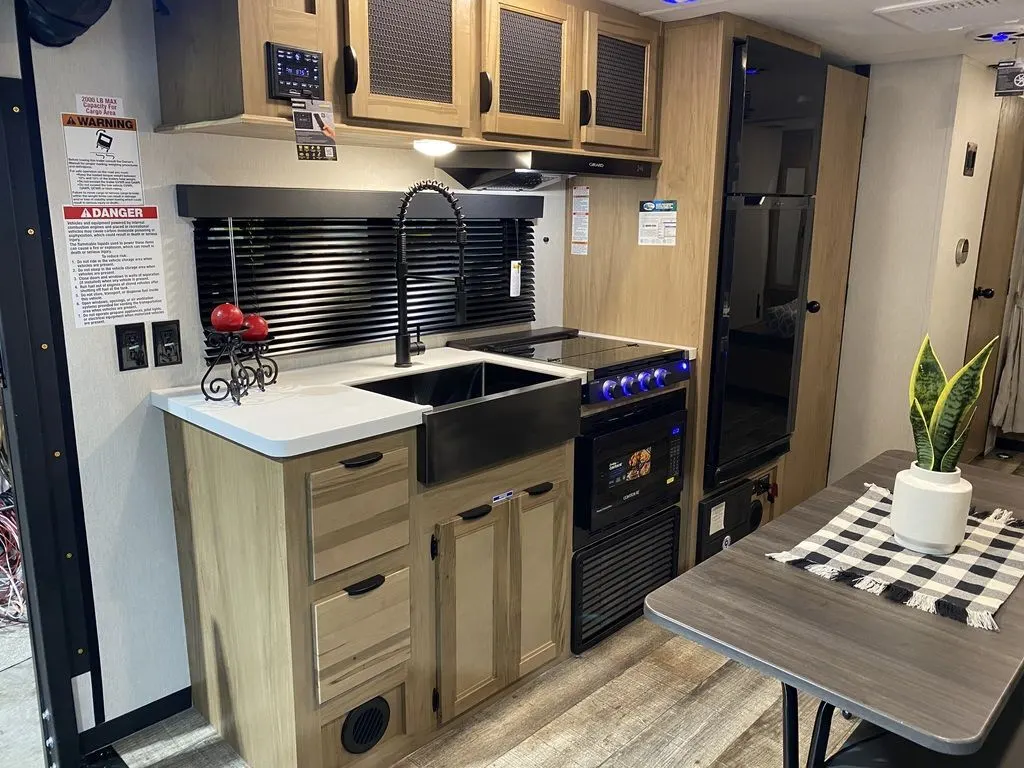Kitchen with a gas range, fridge, sink and cabinets.