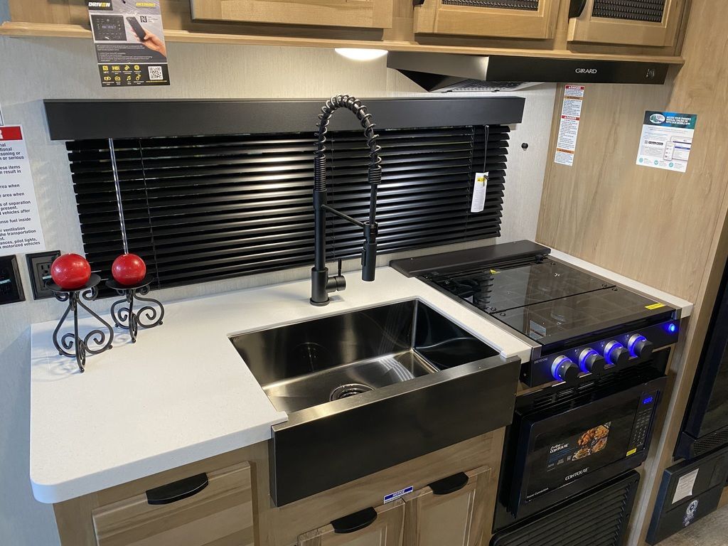 Kitchen with a gas range, sink and cabinets.