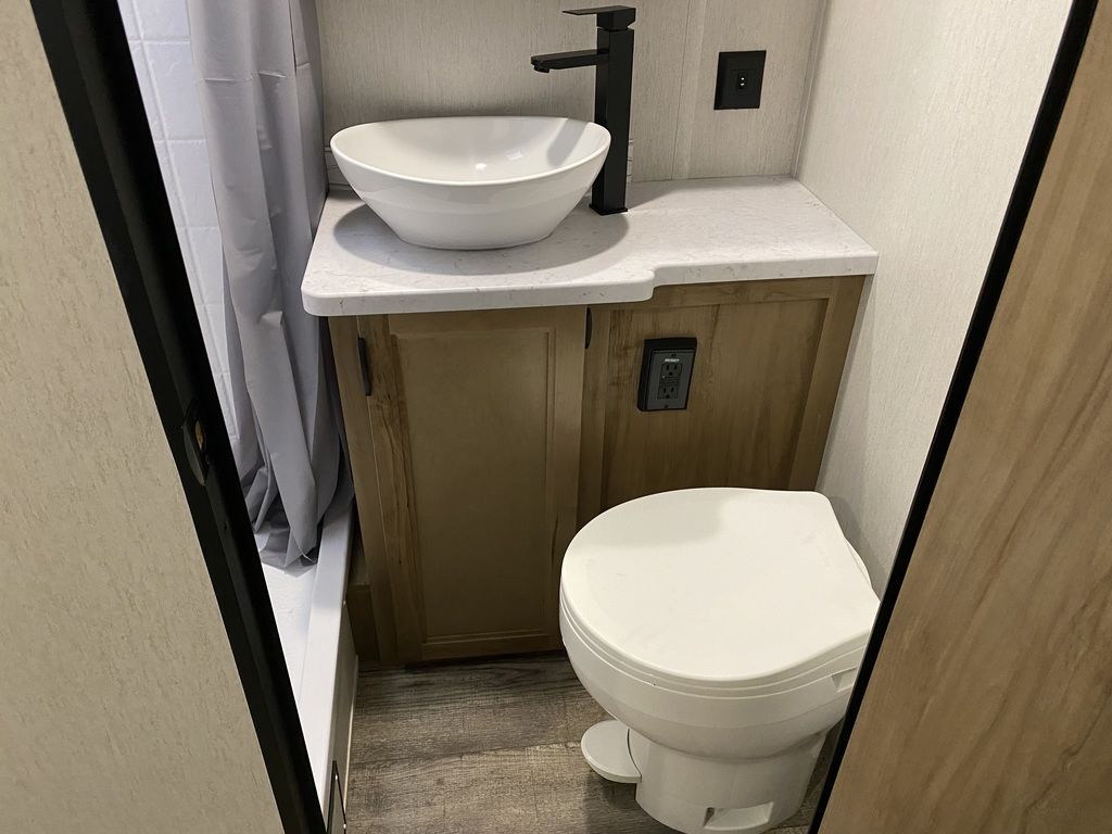 Bathroom with a sink, toilet and a walk-in shower.