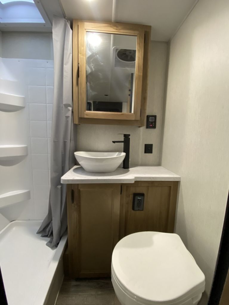 Bathroom with a sink, toilet and a walk-in shower.