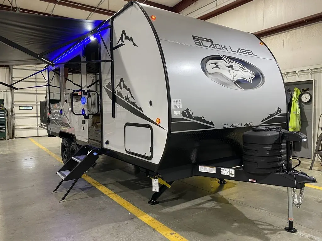 Side view of the New 2024 Forest River Cherokee Grey Wolf 18RR-BL Travel Trailer Toy Hauler RV.