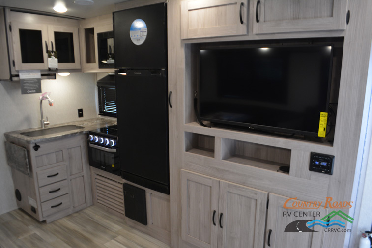 Kitchen with a gas range, fridge, oven, sink and cabinets.