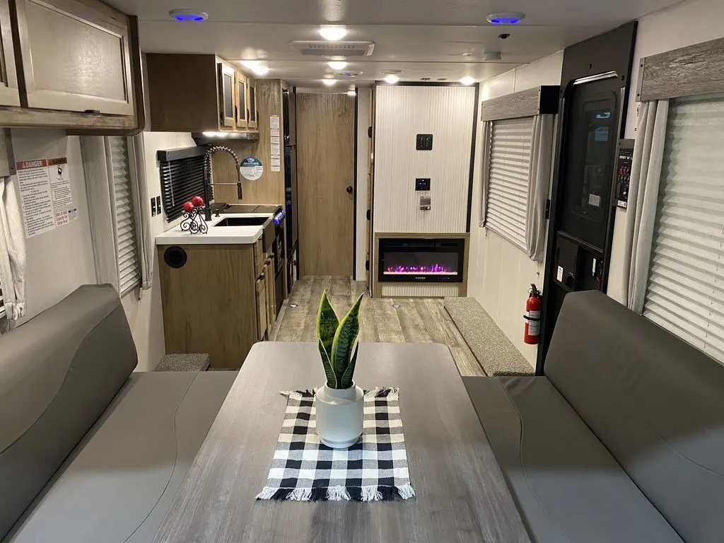 Interior view of the RV with a dinette and a kitchen.