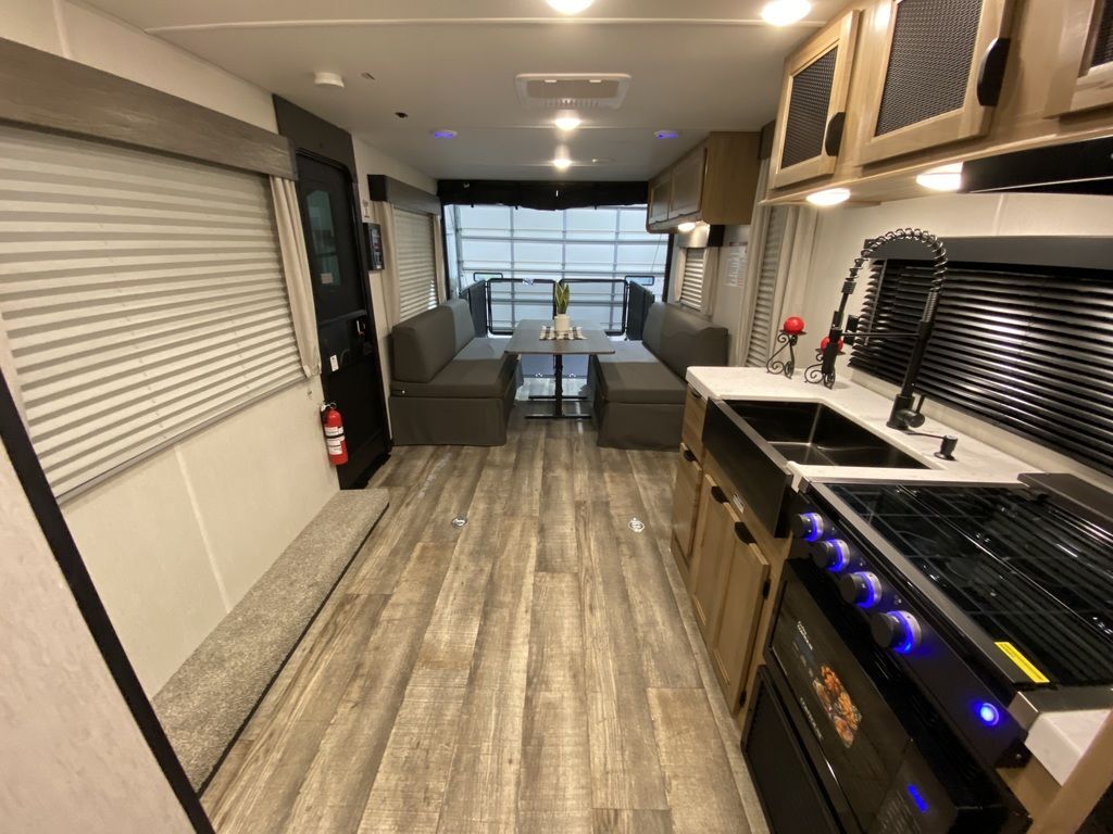 Interior view of the RV with a dinette and a kitchen.