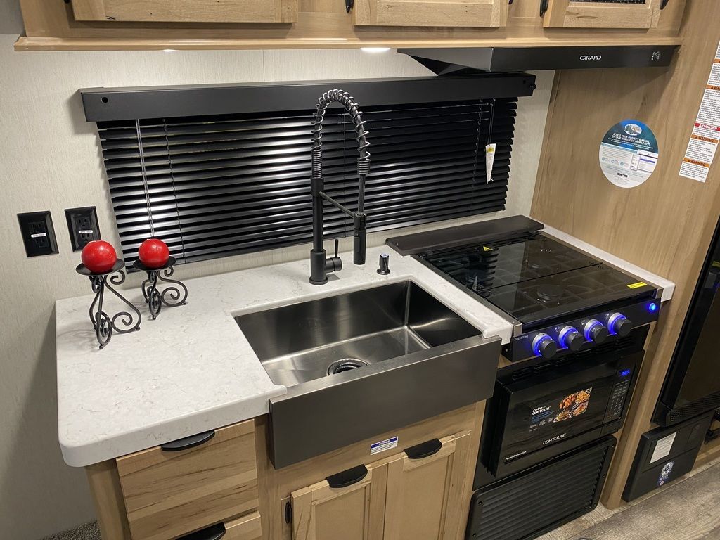 Kitchen with a gas range, sink and cabinets.