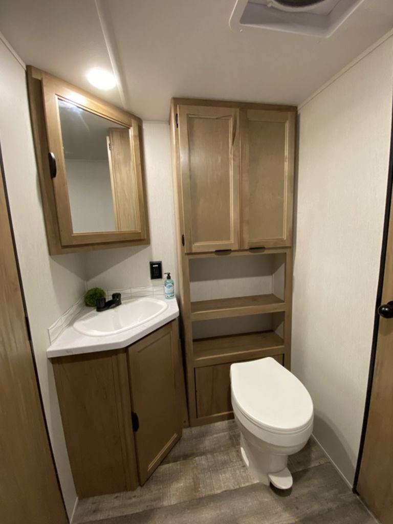 Bathroom with a sink, toilet, linen and a medicine cabinet.