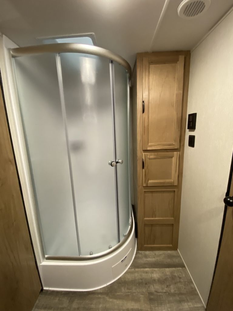 Bathroom with a linen and a walk-in shower.