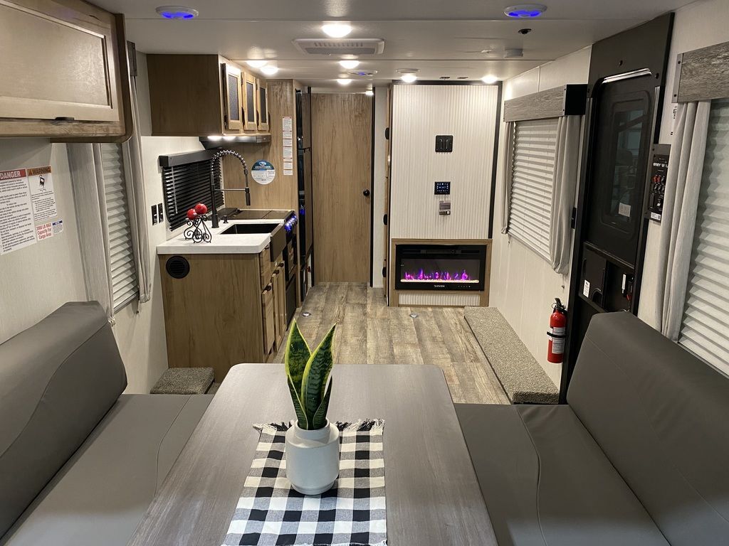 Interior view of the RV with a dinette and a kitchen.