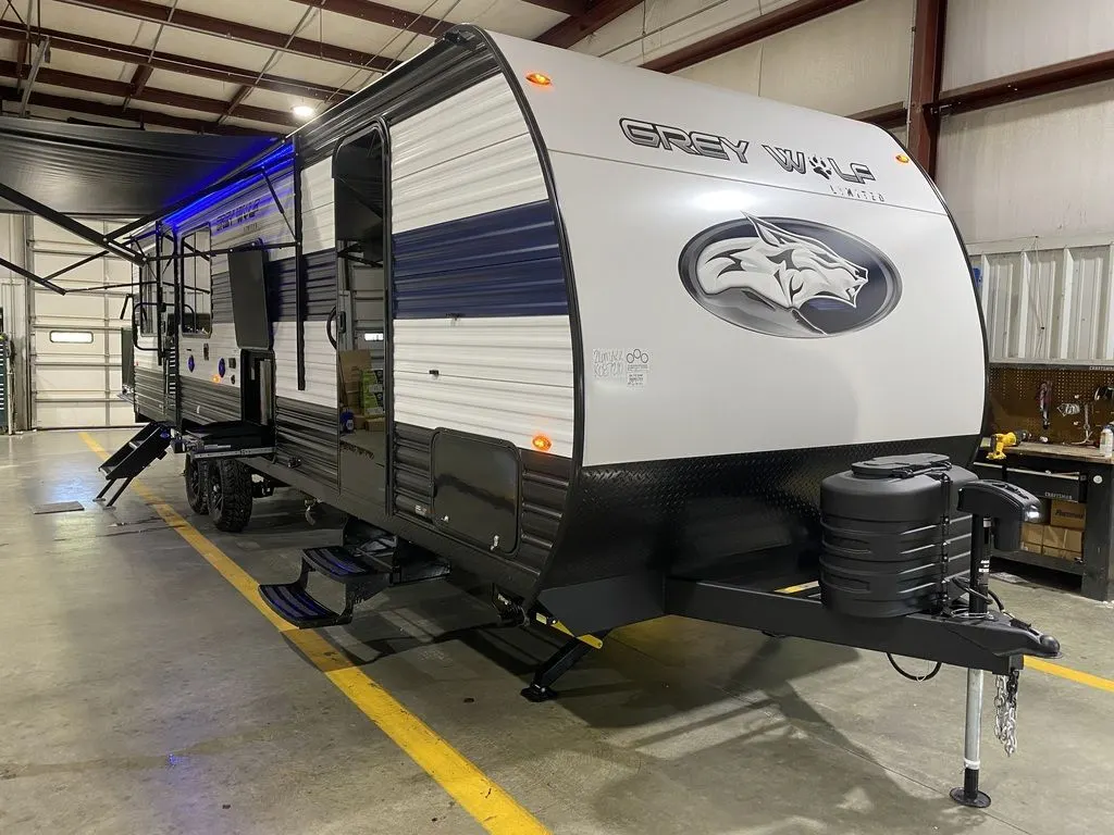 Side view of the New 2024 Forest River Cherokee Grey Wolf 26MBRR Travel Trailer Toy Hauler RV.