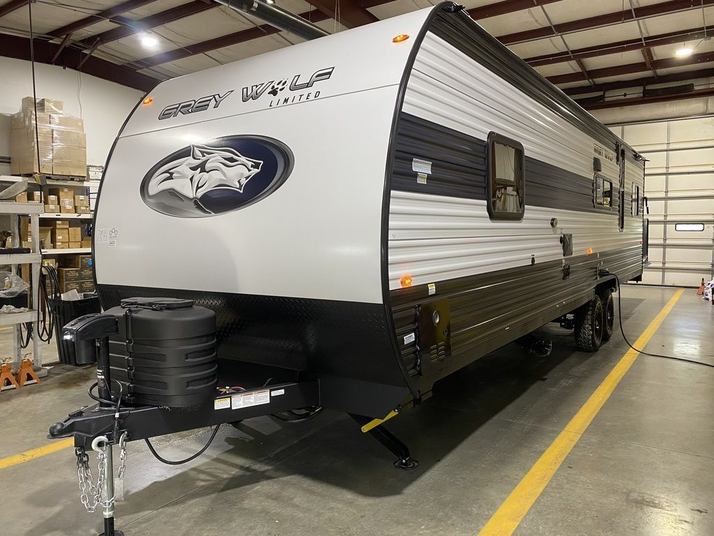 Side view of the New 2024 Forest River Cherokee Grey Wolf 26MBRR Travel Trailer Toy Hauler RV.