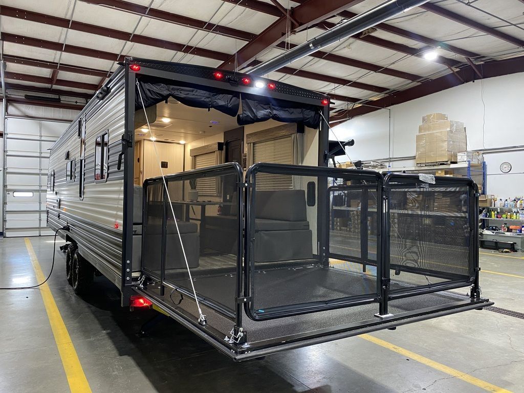 Rear view of the New 2024 Forest River Cherokee Grey Wolf 26MBRR Travel Trailer Toy Hauler RV.